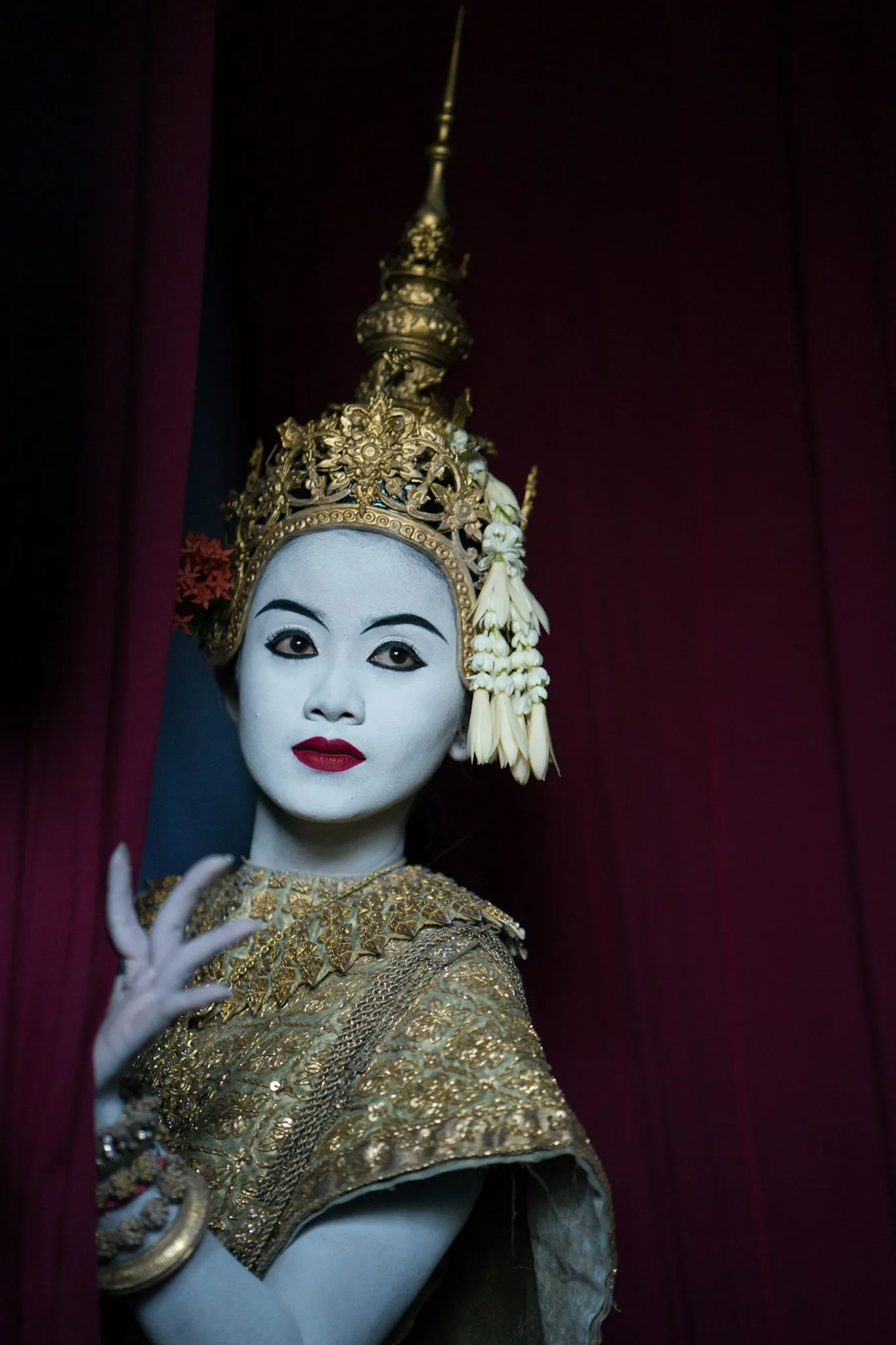 Serei Van Kosaun in classical costume before a crimson curtain